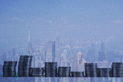 Digital composite image of modern buildings in city against blue sky