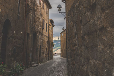 Street amidst buildings against sky in town