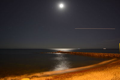 Scenic view of sea against clear sky at night