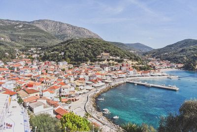 High angle view of townscape by sea against sky