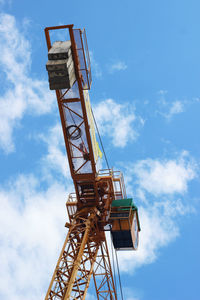 Low angle view of crane against blue sky