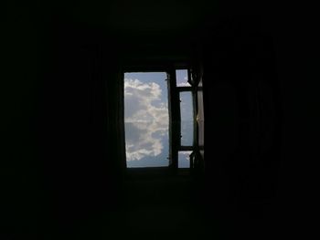 Low angle view of silhouette window in dark room