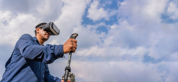 Low angle view of man standing against sky