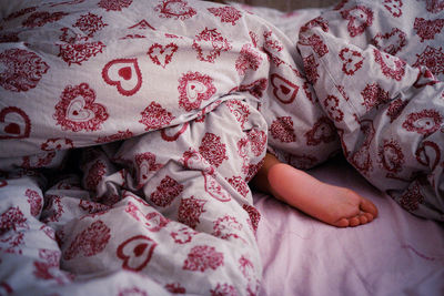 High angle view of woman lying on bed