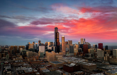 Aerial view of buildings in city against sky during sunset