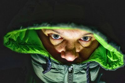 Close-up portrait of man wearing hooded jacket