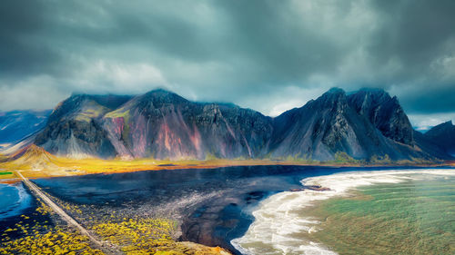 Scenic view of rainbow and mountains against sky
