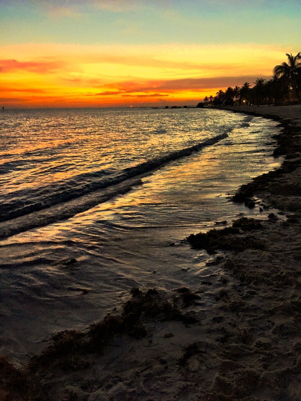 sea, sunset, water, beach, horizon over water, scenics, tranquil scene, tranquility, beauty in nature, sky, shore, orange color, nature, idyllic, wave, sand, coastline, cloud - sky, reflection, outdoors