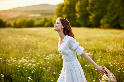 Young woman standing on field