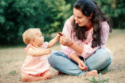 Mother and baby girl with hands