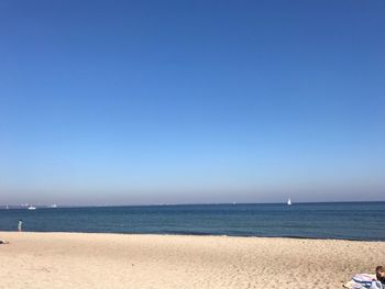 Scenic view of sea against clear blue sky