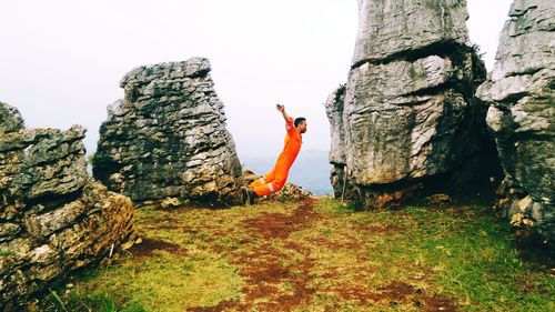 Woman standing on rock formation