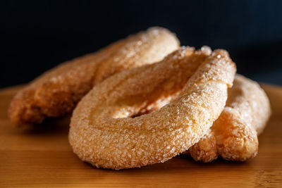 Close-up of bread on table against black background