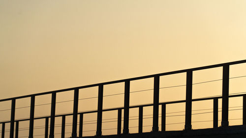 Low angle view of silhouette building against sky during sunset