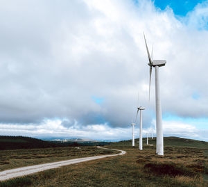 Windmill on field against sky