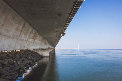 Bridge over sea against sky