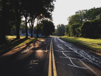 Road amidst trees against sky