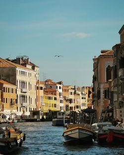 View of canal amidst buildings in city