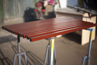 Painted metal profile. steel in brown paint. work in the workshop. sliced steel square pipes.