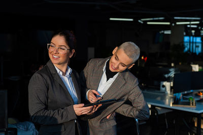 Female entrepreneur looking away while holding digital tablet