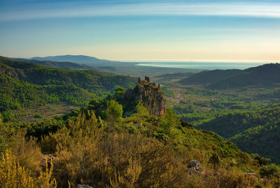 Scenic view of trees and mountains against sky