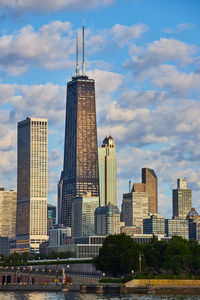 Buildings in city against cloudy sky