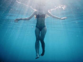 Full length of boy swimming in sea