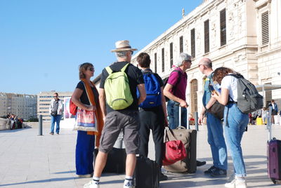 People walking on street against buildings