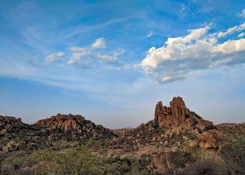 Rock formations on landscape against sky