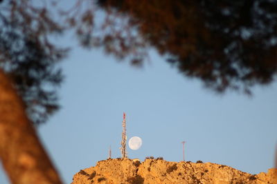 Low angle view of communications tower against sky