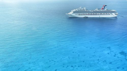 Boat sailing in calm blue sea