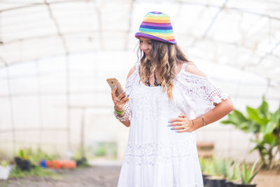 Woman wearing hat standing outdoors