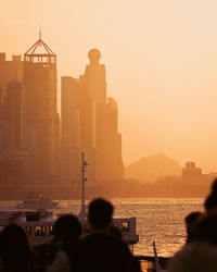 Rear view of people at sunset