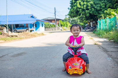 Portrait of cute girl standing on road