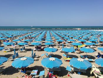 Scenic view of beach against clear blue sky