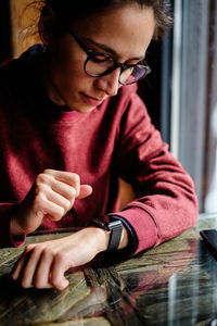 Woman checking time at table