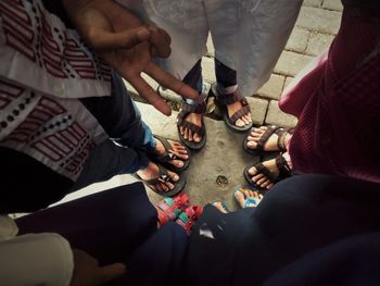 Low section of people sitting on floor