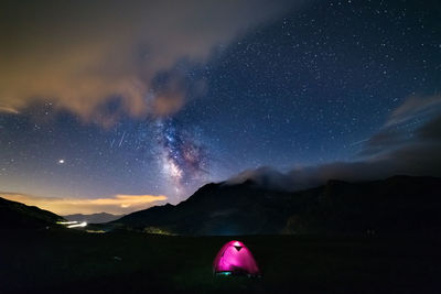 Scenic view of mountains against sky at night