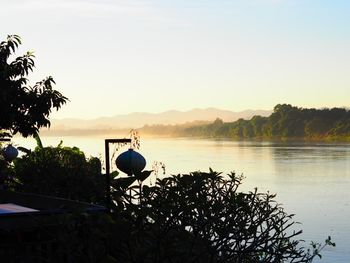 Scenic view of lake against sky during sunset