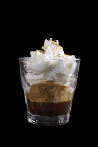 Ice cream in glass against black background