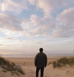 Rear view of man standing on beach