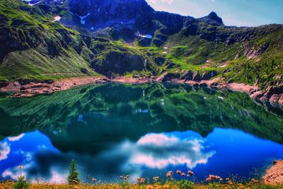 Scenic view of lake and mountains against sky