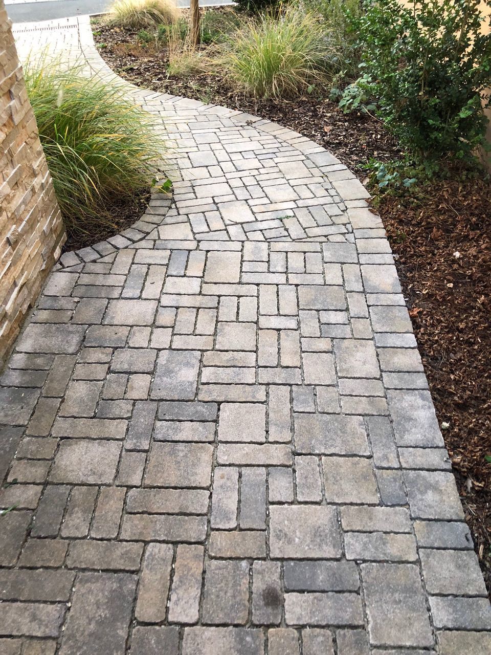 HIGH ANGLE VIEW OF STONE WALL BY FOOTPATH