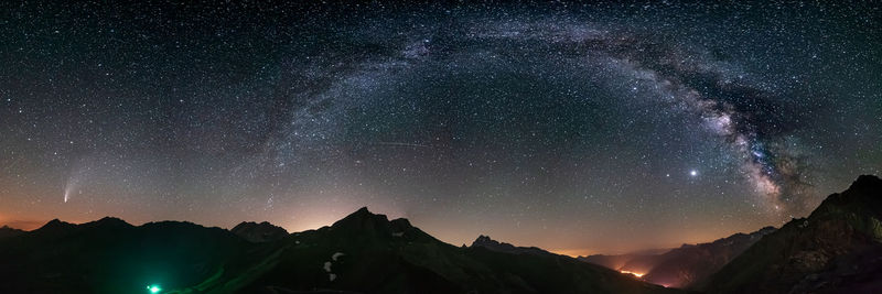 Scenic view of mountains against sky at night