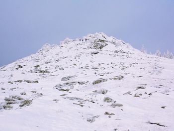 Low angle view of snow covered mountain against sky