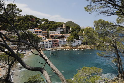 View of townscape by sea against sky