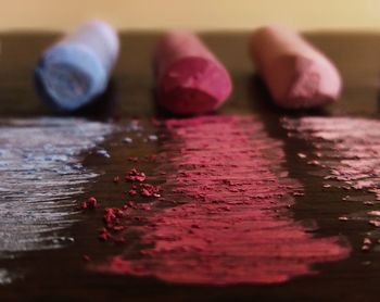 Close-up of colored chalks on table
