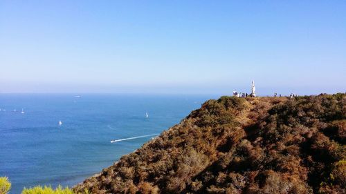 Scenic view of sea against clear blue sky