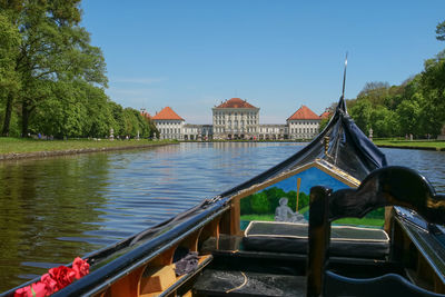 View of boat on lake against clear blue sky during sunny day