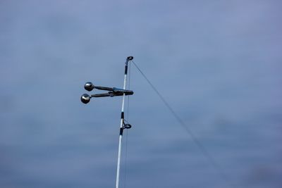 Low angle view of telephone pole against sky